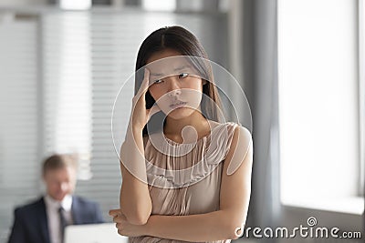 Tired Asian employee feel bored lacking motivation Stock Photo