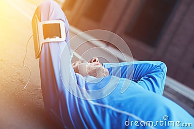 Tired athlete lying on the street after bad running session Stock Photo