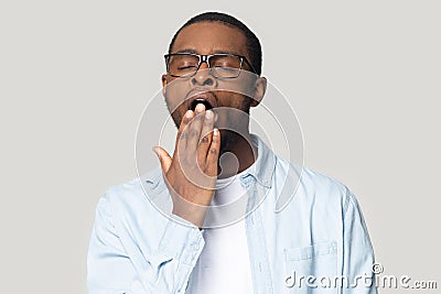 Tired black man feel sleepy cover mouth yawning Stock Photo