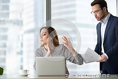 Bothered businesswoman rejecting accept document from colleague Stock Photo