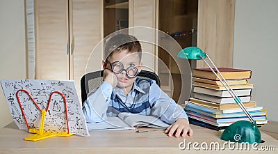 Tired Boy in Funny Glasses Doing Homework. Child With Learning Difficulties. Boy Having Problems With His Homework. Education Stock Photo