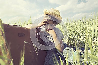 Tired boy sleeps after a long trip on his suitcase Stock Photo