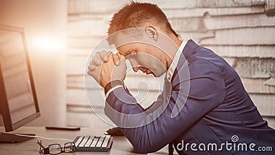 Tired business man at workplace in office holding his head on hands. Sleepy worker early in the morning after late night work. Stock Photo