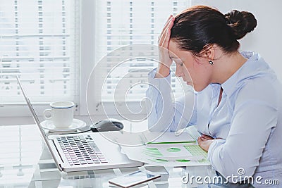 Tired business woman with computer in the office, stress and problems Stock Photo