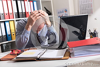 Tired businessman with headache Stock Photo