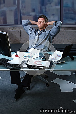 Tired businessman with papers all around Stock Photo