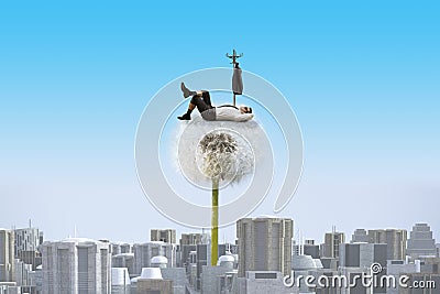 Dandelion towering over a dull city and resting businessman Stock Photo