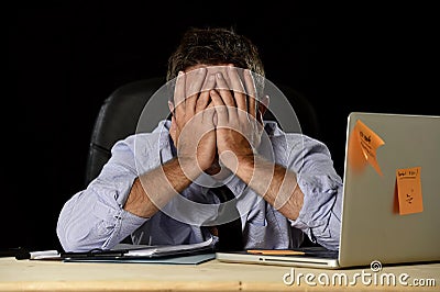 Tired businessman suffering work stress wasted worried busy in office late at night with laptop computer Stock Photo