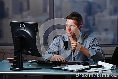 Tired businessman working late in office Stock Photo