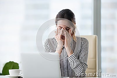 Tired businesswoman massaging eyes feeling strain fatigue headache relieving pain Stock Photo