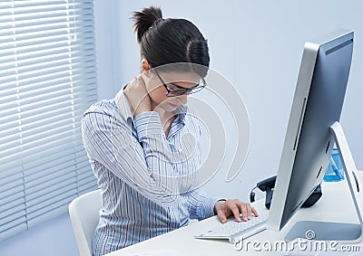 Tired businesswoman with neck pain Stock Photo