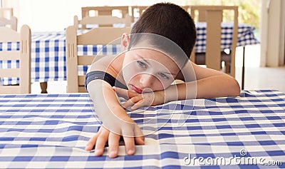 Tired child in restaurant Stock Photo