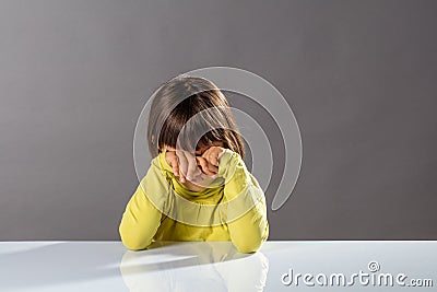 Tired child scratching eyes, crying or feeling bored or sad Stock Photo
