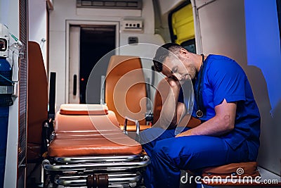 Tired corpsman sleeps inside the ambulance car Stock Photo