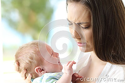 Tired desperate mother and baby crying Stock Photo