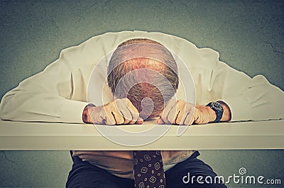 Tired elderly man sleeping in his office Stock Photo