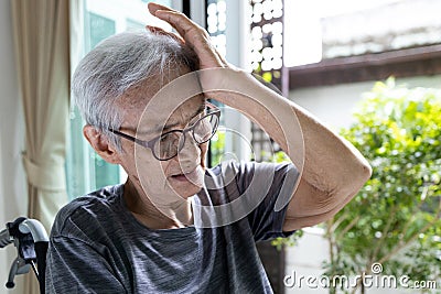 Tired exhausted asian senior woman suffering from migraine headache,old elderly holding head with her hand,feels dizziness,loss of Stock Photo