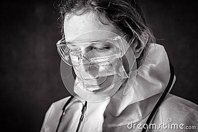 Tired exhausted doctor in personal protective equipment PPE Stock Photo