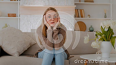 Tired exhausted fatigued stressed ill sick Caucasian woman girl lady at couch home sofa holding head problem thinking Stock Photo