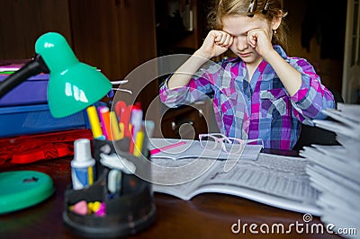 Tired eyes of a child doing homework , writing and learning Stock Photo