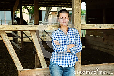Tired worker stands near the corral Stock Photo