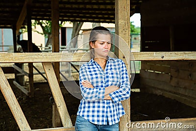 Tired farm worker stands near the corral Stock Photo