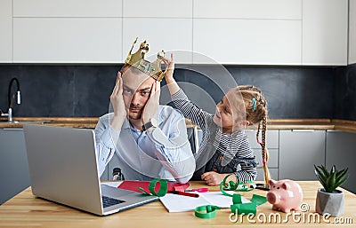 Tired Father Working from home on laptop during quarantine. Stock Photo