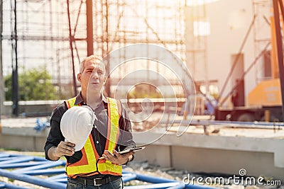 Tired fatigued engineer worker constructor working in construction site Stock Photo