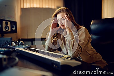 Tired female sound engineer, hard creative process Stock Photo