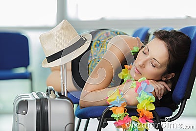 tired female traveler sleeping on airpot departure gates Stock Photo