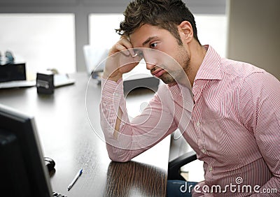 Tired or frustrated office worker looking at computer screen Stock Photo