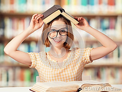 Tired funny girl student with glasses reading books Stock Photo