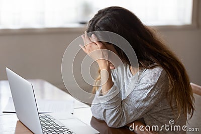 Tired girl having painful feelings due to computer overuse. Stock Photo