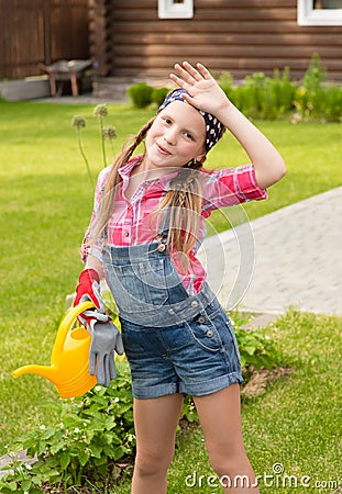 Tired girl wipes the sweat from his brow after working in the garden Stock Photo
