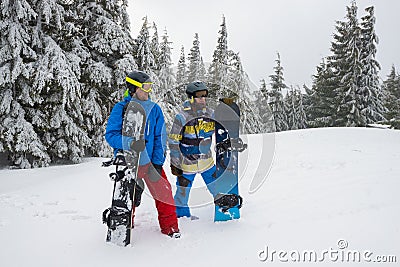 Tired but happy snowboarders relaxes Stock Photo