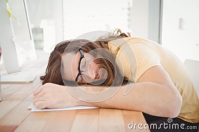 Tired hipster resting at computer desk Stock Photo