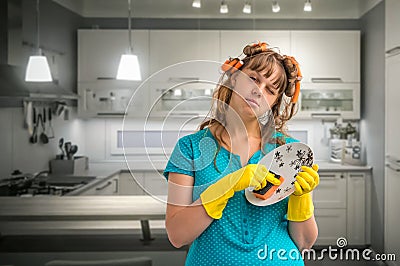 Tired housewife woman washing dishes in kitchen Stock Photo