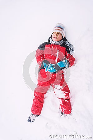 Tired kid in snow Stock Photo