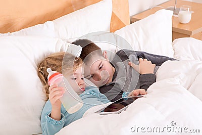 Tired little brother and sister going to sleep Stock Photo