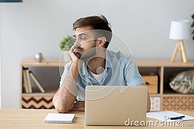 Tired man distracted from computer work lacking motivation Stock Photo