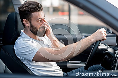 Tired man driving a car Stock Photo