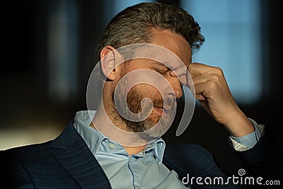 Tired man having a terrible headache. Exhausted man feeling unhealthy, upset about headache illness. Closeup portrait of Stock Photo