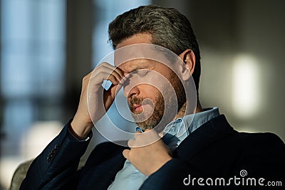 Tired man having a terrible headache. Exhausted man feeling unhealthy, upset about headache illness. Closeup portrait of Stock Photo