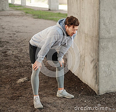 Tired man after street workout alone in a city Stock Photo