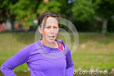 Tired middle-aged woman jogger resting Stock Photo