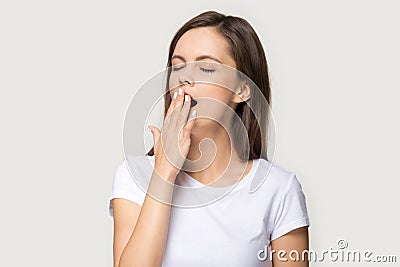 Tired young woman yawning having sleep deprivation Stock Photo