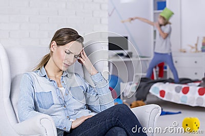 Tired mother of hyperactive child Stock Photo