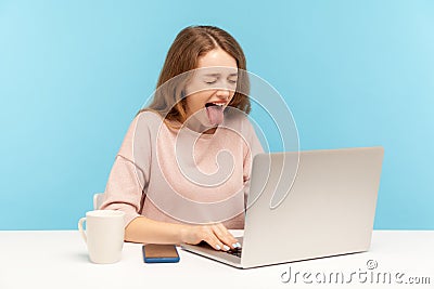 Tired naughty overworked woman in casual clothes showing tongue out, expressing disgust and disobedience Stock Photo