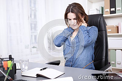 Tired Office Woman Massaging the Back of her Neck Stock Photo