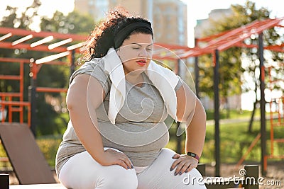 Tired overweight woman with towel resting Stock Photo